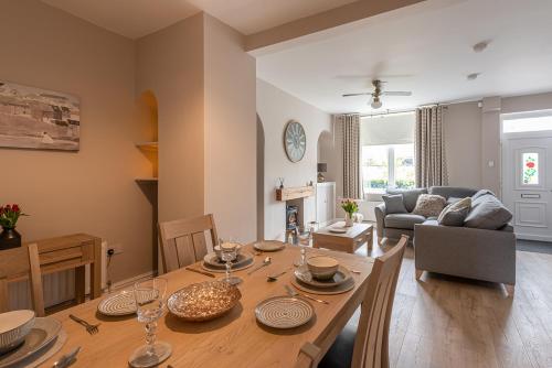 a living room with a table and a couch at Dales Edge - Skipton in Skipton