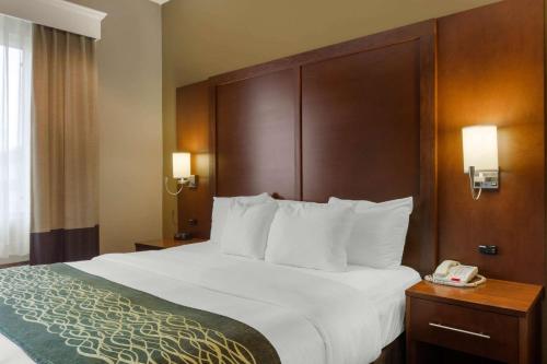 a hotel room with a large bed and a phone at Comfort Inn & Suites Amarillo East in Amarillo
