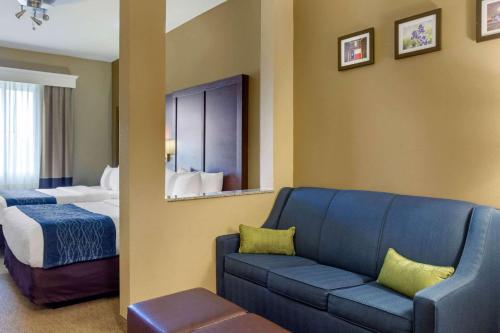 a hotel room with a couch and a bed at Comfort Inn & Suites Amarillo East in Amarillo