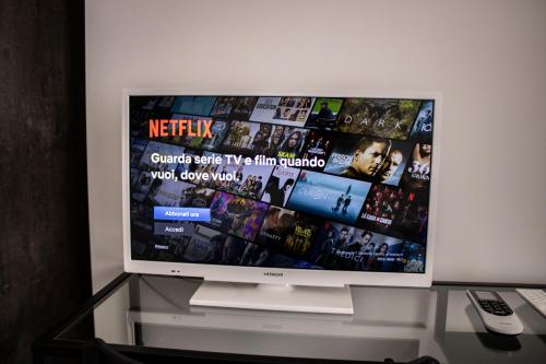 a flat screen tv sitting on top of a glass table at InCentroScalea B&B in Scalea