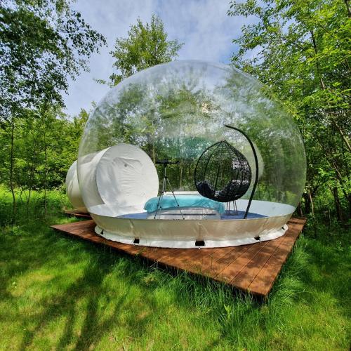 a dome house on a wooden platform in the grass at W BAŃCE Glamping in Łódź