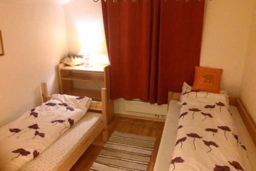 A bed or beds in a room at Lofoten Apartment + Rooms - Skrova
