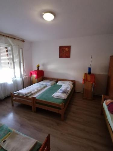 a bedroom with a large bed in a room at Malomtavi Vendégház in Tapolca