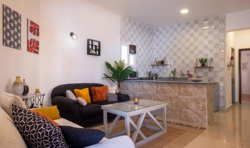 a living room with a couch and a kitchen at Villa Can Kiko in Dahab