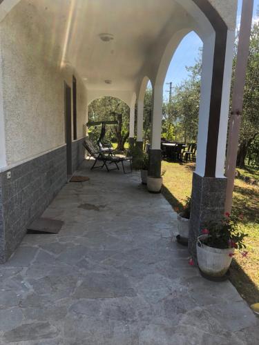 an outdoor patio with a stone floor and an archway at Villa ELENA in Mezzanego