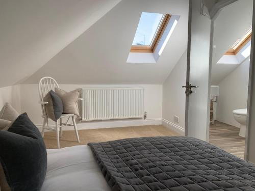 a bedroom with a bed and a bathroom with a window at No11 in Lewes