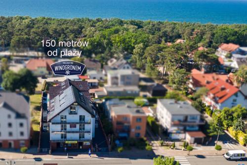 a town with a sign that reads memory of play at Pod Winogronem - Apartamenty z basenem i wyżywieniem in Pobierowo