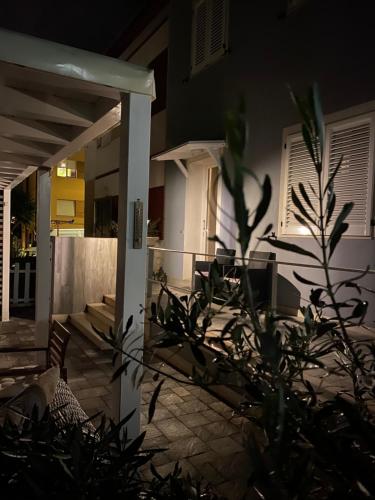 a house at night with a plant in the foreground at AlCivico3 in Civitanova Marche