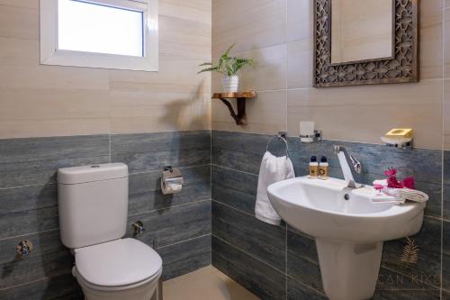 a bathroom with a white toilet and a sink at Villa Can Kiko in Dahab