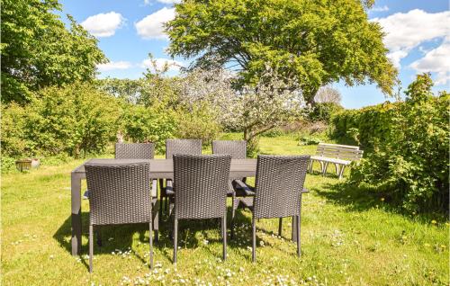 a table and chairs sitting in the grass at Stunning Apartment In Skanderborg in Skanderborg