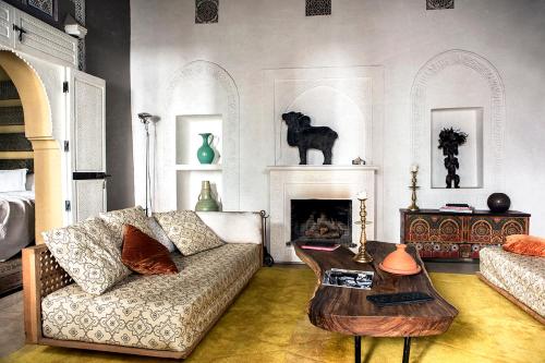 a living room filled with furniture and a fireplace at Ryad Dyor in Marrakesh