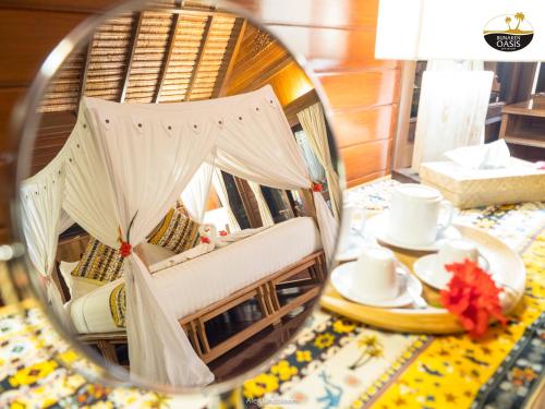 a reflection of a room with a chair in a mirror at Bunaken Oasis Dive Resort and Spa in Bunaken