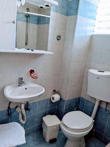 a bathroom with a toilet and a sink at Hotel Ionio in Katakolon
