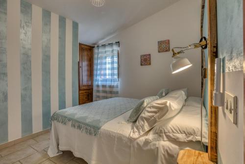 a bedroom with a bed and a lamp in it at Trulli Terra Magica in Putignano