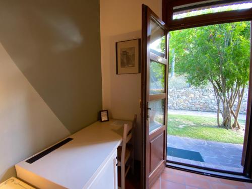 a room with a desk and a large window at Agriturismo Tenuta Badia in Paciano
