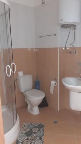 une salle de bains avec toilettes, lavabo et douche dans l'établissement Complex Oazis, à Ravda