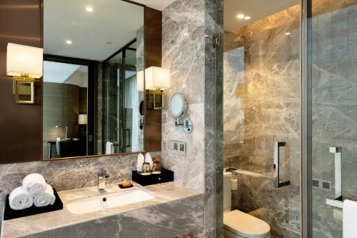 a bathroom with a sink and a shower at Crowne Plaza Nanning City Center by IHG in Nanning