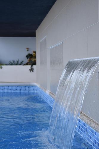 a water fountain in a swimming pool at Casa da Vitoria in Falca
