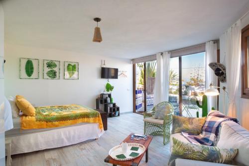 a bedroom with a bed and a living room at Villa La Perla in Candelaria