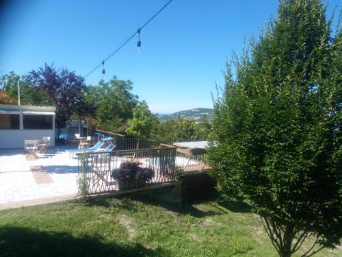 a view of a yard with a fence and a tree at Albergo Diffuso - Il Poggetto tra Urbino & San Marino in Urbino
