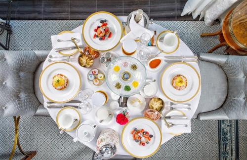 
a white table topped with plates of food at Four Seasons Hotel Lion Palace St. Petersburg in Saint Petersburg
