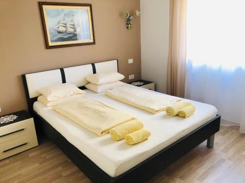 a bedroom with a bed with two pillows on it at Apartment Gio in Novigrad Istria