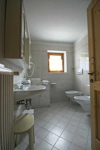 a bathroom with two sinks and two toilets at Bachlaufen Haus in Sesto