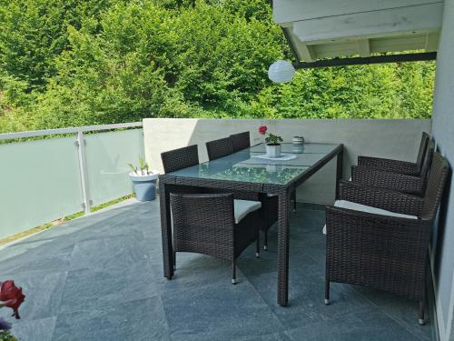 a glass table and chairs on a patio at Ferienwohnung Melanie in Kirchbach