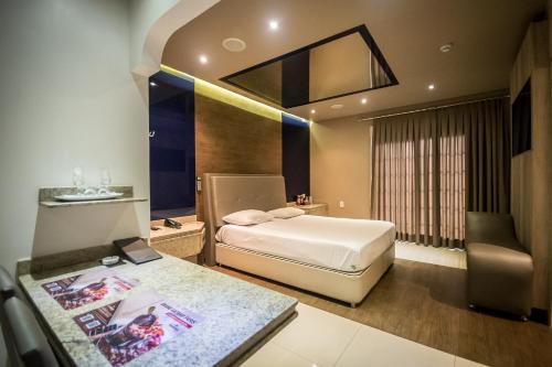 Łóżko lub łóżka w pokoju w obiekcie Caribe Motel (Adult Only)