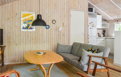 a living room with a couch and a table at 2 Bedroom Lovely Home In Sæby in Sæby