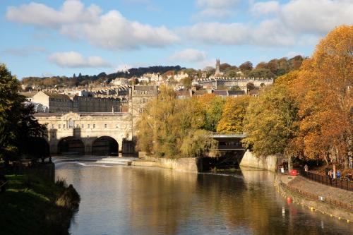a bridge over a river with a city in the background at Royal Hotel in Bath
