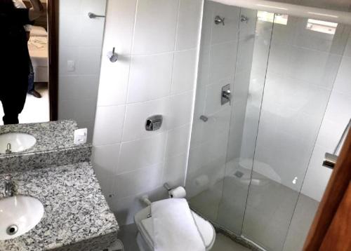 a bathroom with a shower and a toilet and a sink at Serra Linda Hotel in Serra