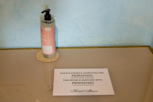 a sign on the top of a bathroom counter with a blow dryer at Hotel Abaco in Florence