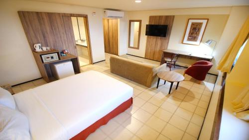 a hotel room with a bed and a desk at Holiday Inn Fortaleza by IHG in Fortaleza