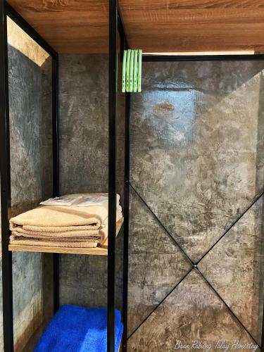 a room with a bunk bed with a glass door at Baan Rabieng Talay Homestayบ้านระเบียงทะเล โฮมสเตย์เกาะกูด in Ko Kood