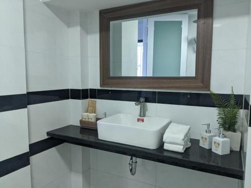 a bathroom with a white sink and a mirror at Tuấn Ninh Hotel I in Con Dao