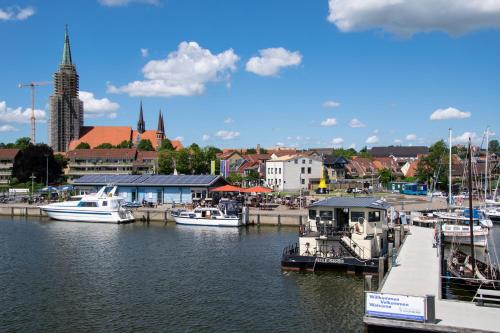 a group of boats docked at a dock in a harbor at Island-dreams Hausboot Cecilie in Schleswig