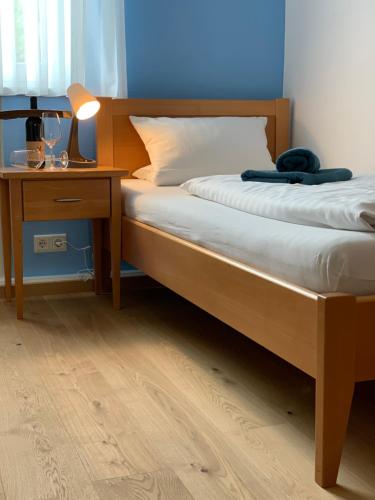 a bedroom with a bed and a night stand with a lamp at Landshuter Hof in Straubing
