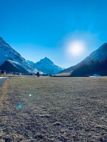 an empty field with mountains in the background at Apart Lisun in Galtür