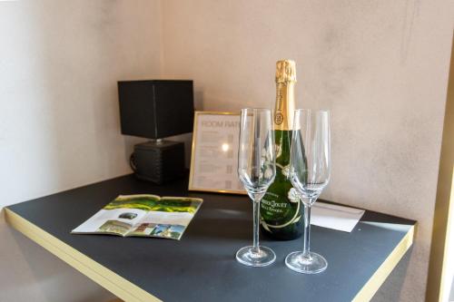 a table with a bottle of champagne and two wine glasses at Timeout Heritage Hotel Zagreb in Zagreb