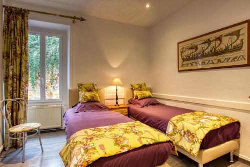 - une chambre avec 2 lits et une fenêtre dans l'établissement La licorne sarladaise, à Sarlat-la-Canéda