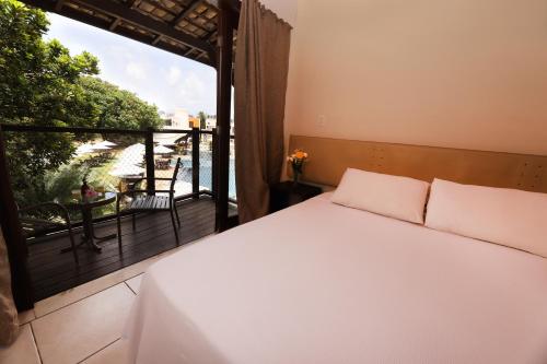 Un pat sau paturi într-o cameră la Sun Bay Pipa Hotéis