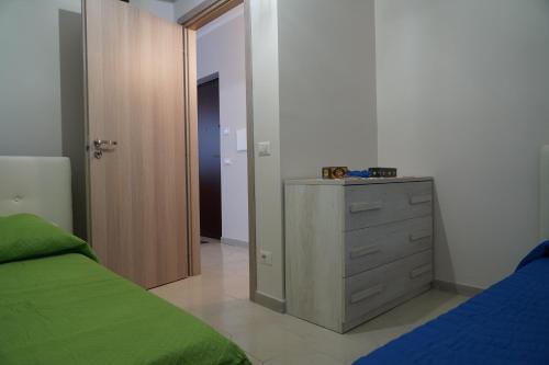 a bedroom with a bed and a dresser with a mirror at Il Vicoletto in Pimonte