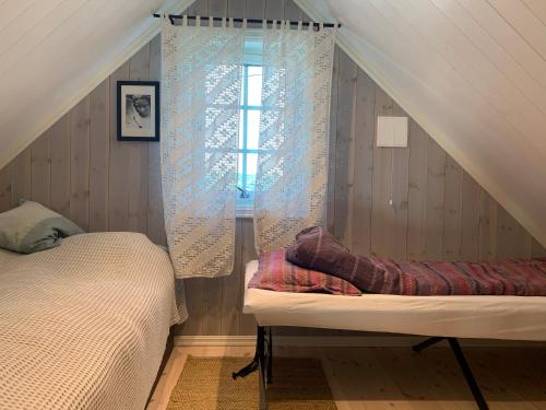 a bedroom with a bed and a window at The Gingerbread House in Lillehammer