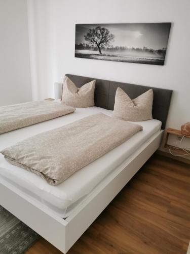 a bedroom with two beds and a tree on the wall at Appartements Told Elisabeth in Fügen