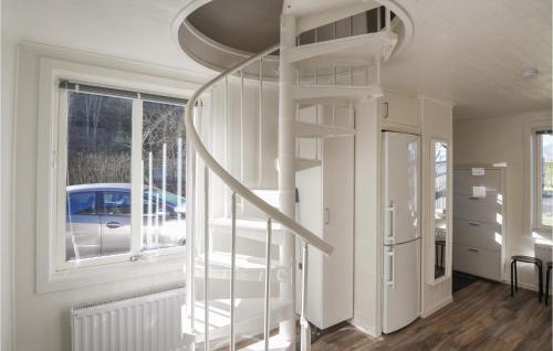 a spiral staircase in a room with a window at Awesome Home In Alingss With 1 Bedrooms And Wifi in Alingsås