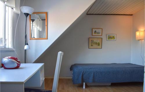 a room with a bed and a table and a staircase at Awesome Home In Vittsjö in Vittsjö