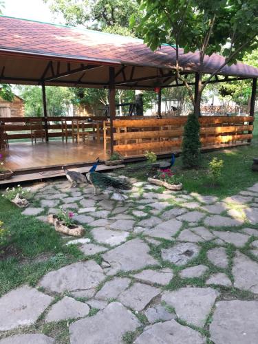 a stone patio with a wooden gazebo at Harsnadzor Eco Resort in Halidzor