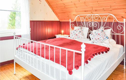 a bedroom with a white bed with a red blanket at Beautiful Home In Filipstad With Kitchen in Filipstad