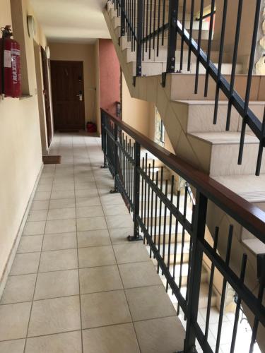 an empty hallway with stairs in a building at Lili Apartman Birdland Bükfürdő in Bük